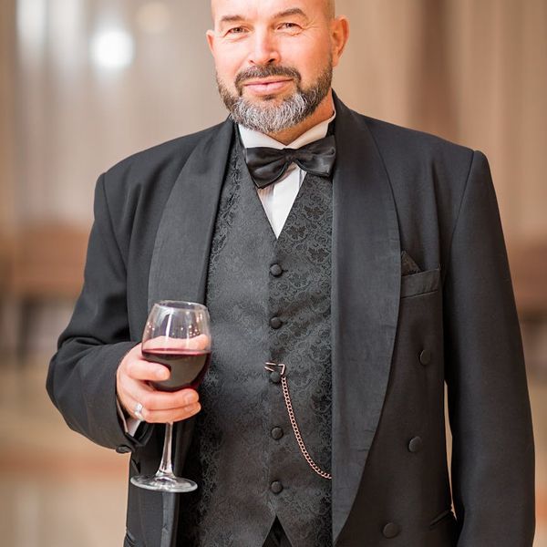 A man stretching calmly in a minimalist environment with warm light.